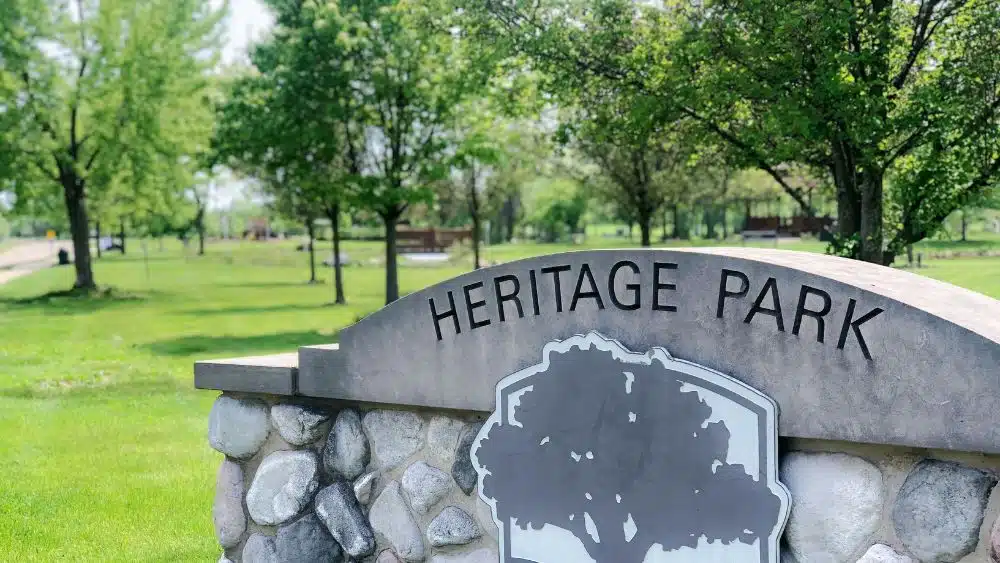 City par with a stone sign reading, "Heritage Park."