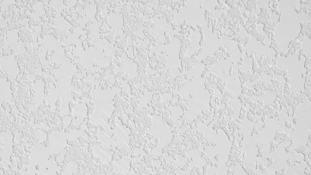Textured drywall with large smoothed patches randomly, creating a map-like effect.