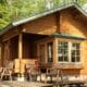 wooden tiny home with table and chairs on the terrace