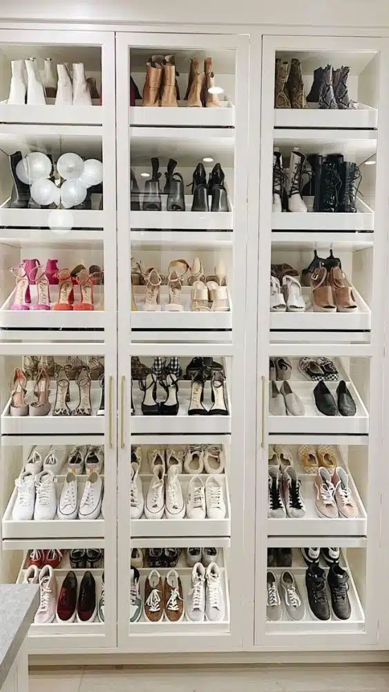 Large, double-door closet with glass doors showing organized shoes.