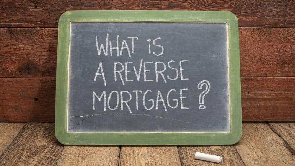 Chalkboard sign with a green border that reads, "What is a reverse mortgage?"