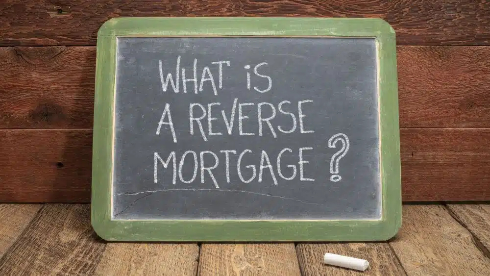 Chalkboard sign with a green border that reads, "What is a reverse mortgage?"