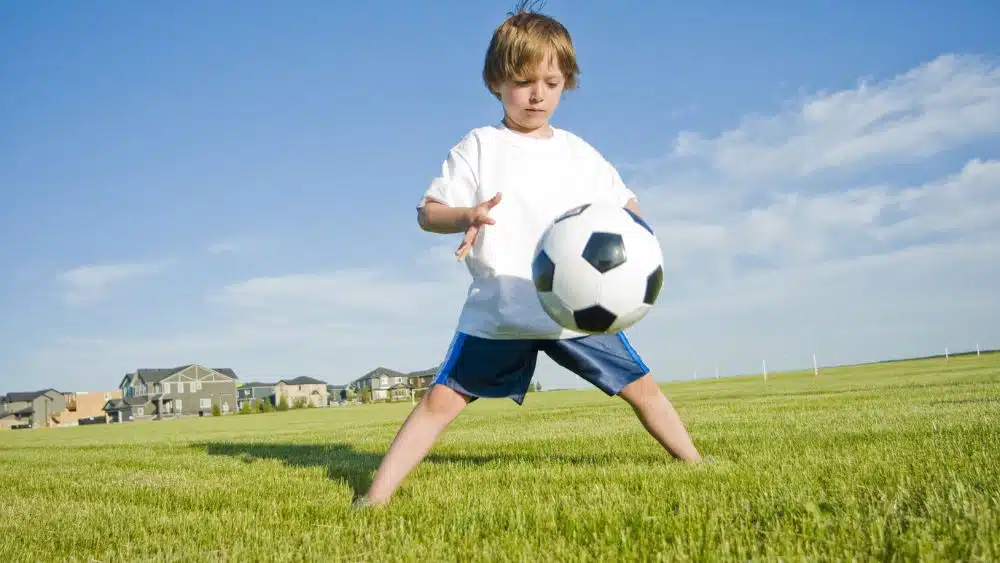 boy playing with a soccer ball
