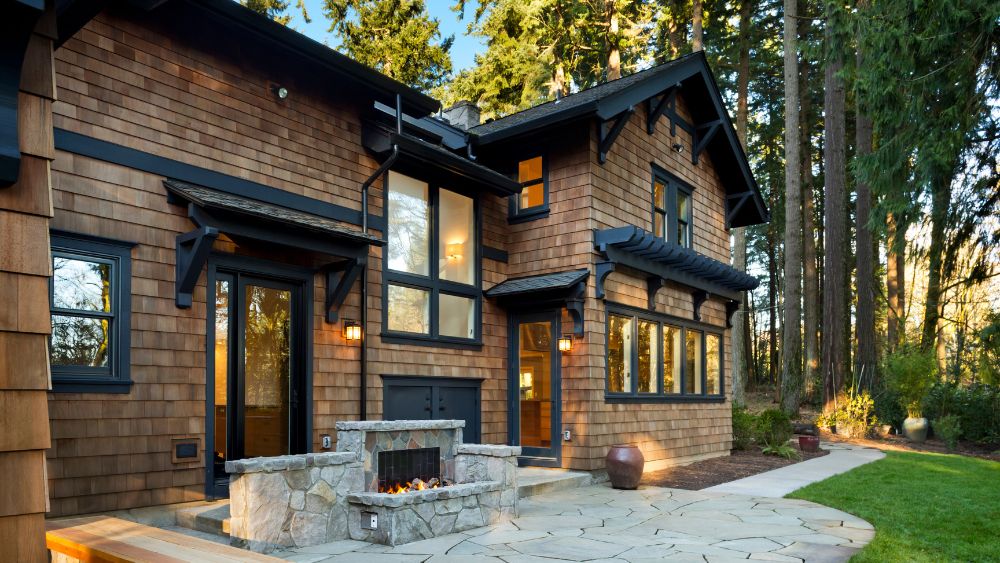 A cozy back patio featuring a stone fireplace.