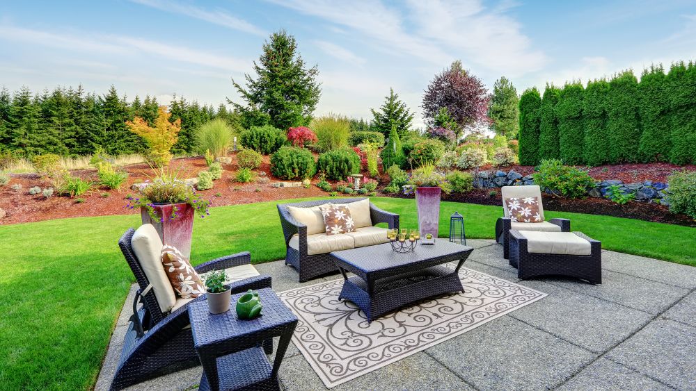 Backyard patio with fall cushions and rug.